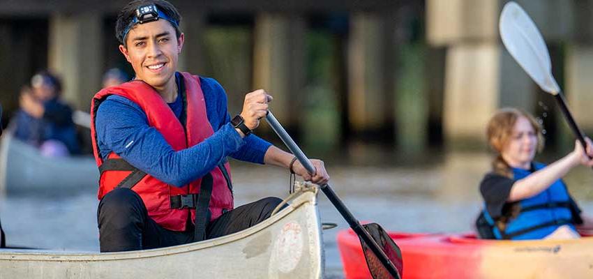 Male student in kayak in water