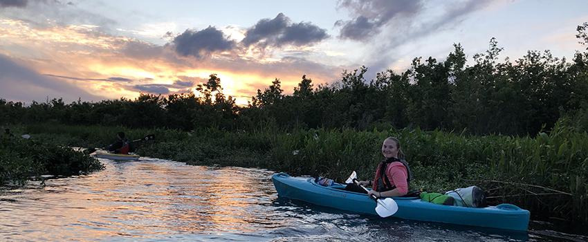 Female student in kayak in water